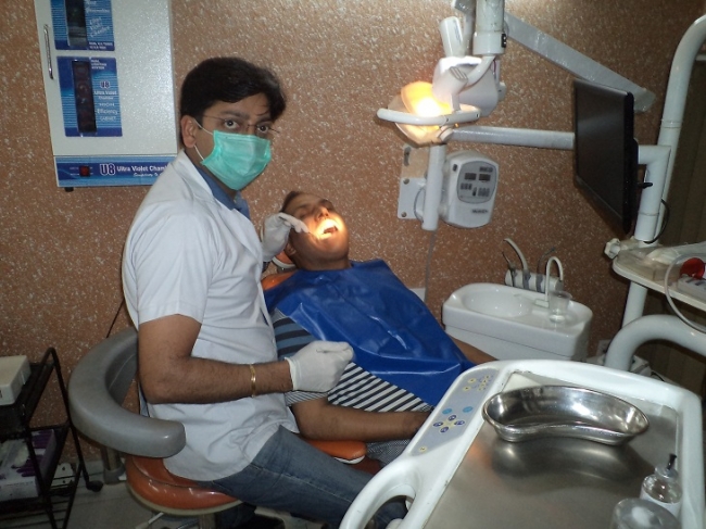 Dr Arora Dental Clinic - Dr Rajeev examining the patient